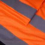 Close-up of bright orange high-visibility mesh fabric with two grey reflective safety stripes stitched across it.