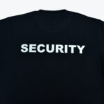 The back of a black t-shirt with SECURITY printed in bold white letters.