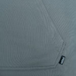 Close-up of a grey hoodie kangaroo pocket featuring double-stitching and a small black Addos label.
