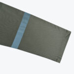 Close-up of an olive green jacket sleeve with a light blue reflective stripe on a white background.
