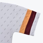 Close-up of a white addos shirt sleeve featuring a repeating grey logo pattern, accented with thick orange and maroon stripes near the cuff.