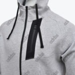 Close-up of a grey Addos zip-up hoodie featuring a black chest pocket zipper, black drawstrings.