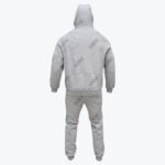Back view of a grey Addos tracksuit consisting of a hoodie with the hood up and matching sweatpants.