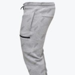 Side view of grey Addos joggers with a black zippered thigh pocket.
