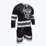 A black and white sports uniform set featuring a long-sleeve jersey with a skull and helmet logo and matching shorts with the number 29 on a plain white background.