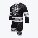 A black and white hockey jersey and shorts set with a skull and shield logo on the front, displayed against a white background.