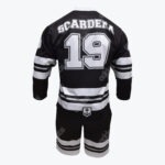 Back view of a black and white hockey jersey with the name SCARDERA and number 19, paired with matching striped shorts.