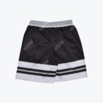 A pair of black and white Addos athletic shorts with a striped bottom hem and grey waistband on a white background.