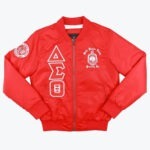A bright red bomber jacket with white Delta Sigma Theta Greek letters vertically on the right chest, the sorority crest on the left chest, and a circular patch on the right sleeve, set against a white background.