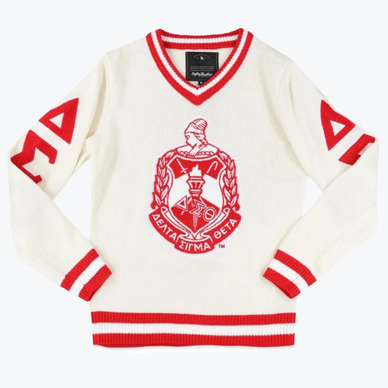 A cream-colored V-neck sweater with red and white striped trim, featuring a large red Delta Sigma Theta crest on the front and red Greek letters on the sleeves.