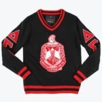 A black V-neck knit sweater with a large red and white Delta Sigma Theta crest on the chest and red Greek letters on the sleeves.