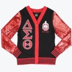A black cardigan sweater with red sequined sleeves, featuring the Greek letters Delta, Sigma, and Theta on the right and the sorority's crest with EST. 1913 on the left.