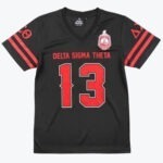 A black V-neck jersey with DELTA SIGMA THETA and the number 13 printed in red on the front, featuring the sorority crest on the left chest.