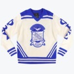 A cream and royal blue knit v-neck sweater featuring the Phi Beta Sigma fraternity crest on the front and Greek letters on the sleeves.