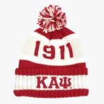 A red and white knit beanie with a pom-pom on top. The year 1911 is written in red on a white band across the middle, and the Greek letters Kappa Alpha Psi (ΚΑΨ) are embroidered on the folded cuff.