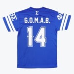 The back view of a royal blue jersey featuring G.O.M.A.B. and the number 14 printed in white, with Phi Beta Sigma fraternity Greek letters on the sleeves.
