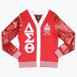 A red cardigan jacket with sparkly red sequin sleeves, featuring the Greek letters Delta, Sigma, and Theta stacked vertically on one side and the sorority crest with EST. 1913 on the other.