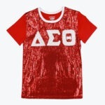 A red t-shirt with a shiny red sequined front, solid red sleeves, a white crew neck collar, and the Greek letters Delta, Sigma, Theta in white glitter across the chest.