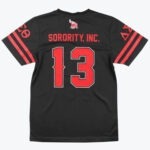 The back view of a black Delta Sigma Theta jersey featuring SORORITY, INC. and the number 13 in red, with an elephant logo and Greek letters on the sleeves.