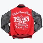 The back of a red varsity jacket with black leather sleeves, featuring white embroidered text for Delta Sigma Theta Sorority, Inc., the year 1913, and a central triangle emblem.