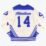 Back view of a cream and blue knit sweater with Nineteen 14 printed on the back in varsity style.