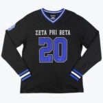A black long sleeve jersey shirt with ZETA PHI BETA and the number 20 in blue on the front featuring a blue and white striped collar and cuffs.