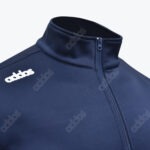 Close-up of a navy blue athletic jacket with a high collar, zipper, and an embroidered white logo reading addos on the chest.