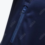 Close-up of a navy blue Addos fabric with a repeating logo pattern and a matching blue zipper.
